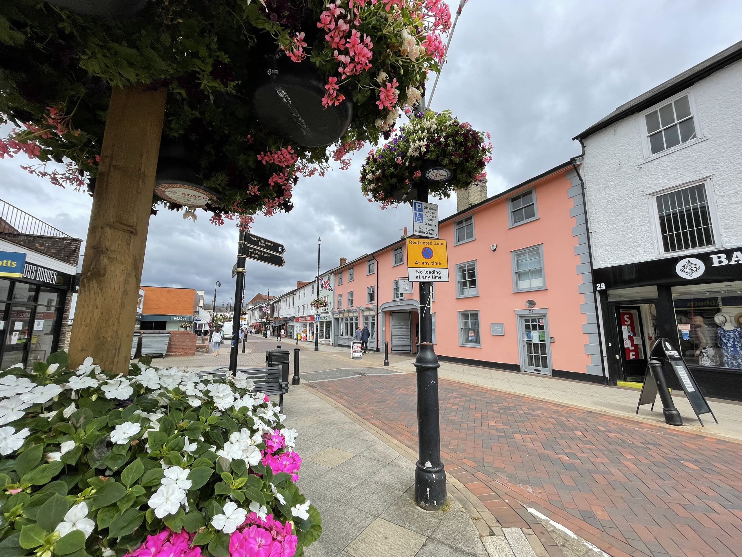 Stowmarket town centre shopping street with hanging flower baskets