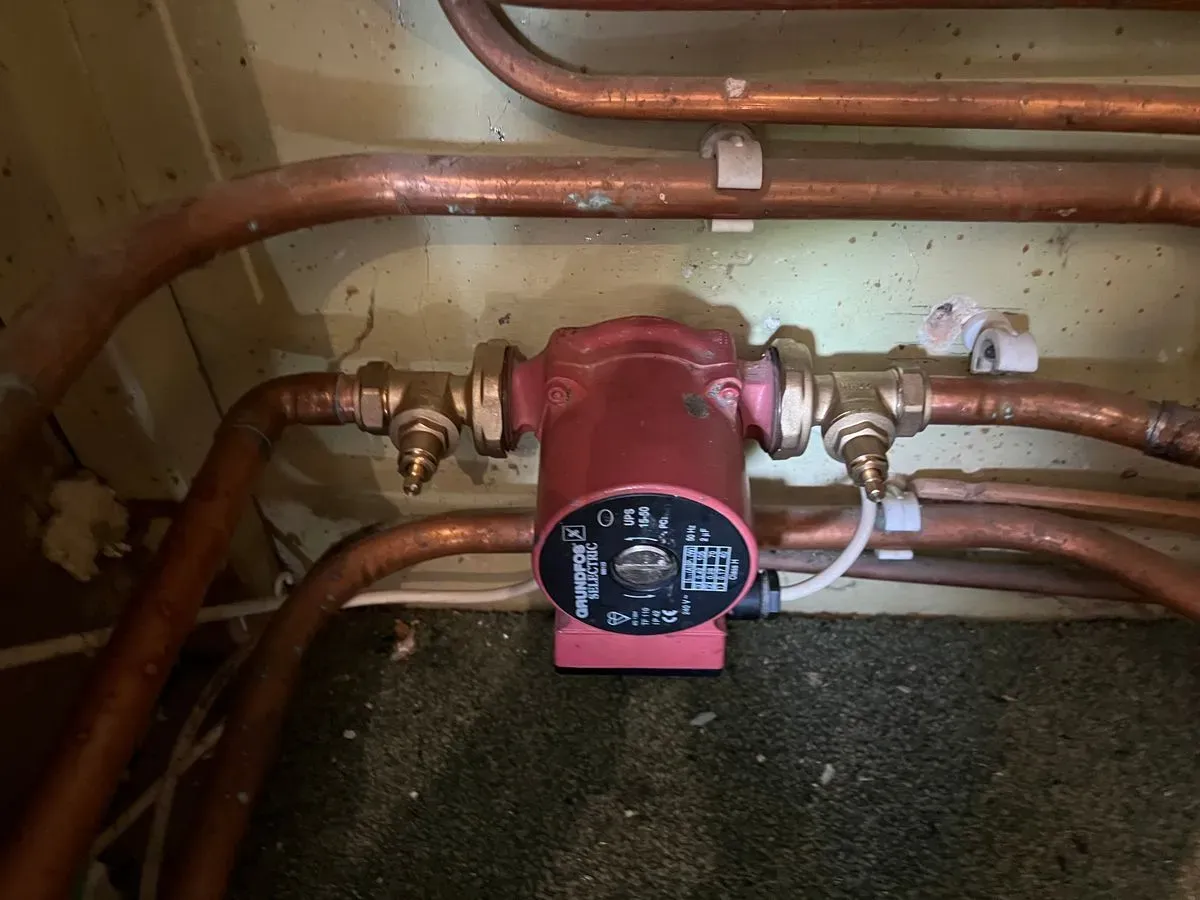 Red circulation pump fitted to copper pipework